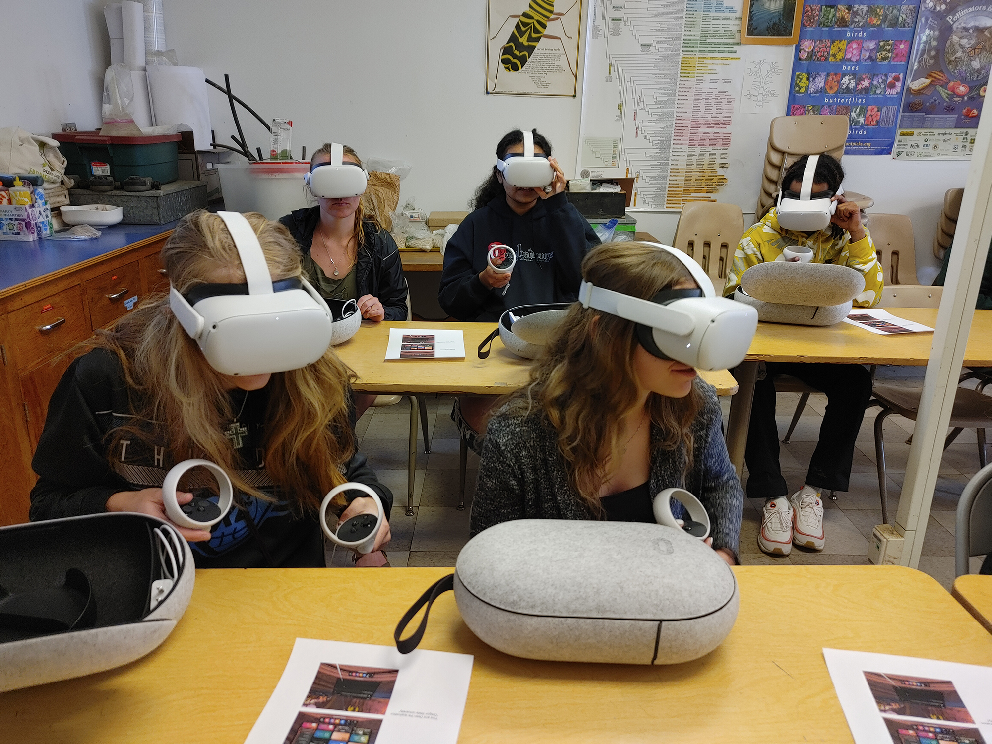 Youth in classroom with Virtual Reality headsets over their eyes