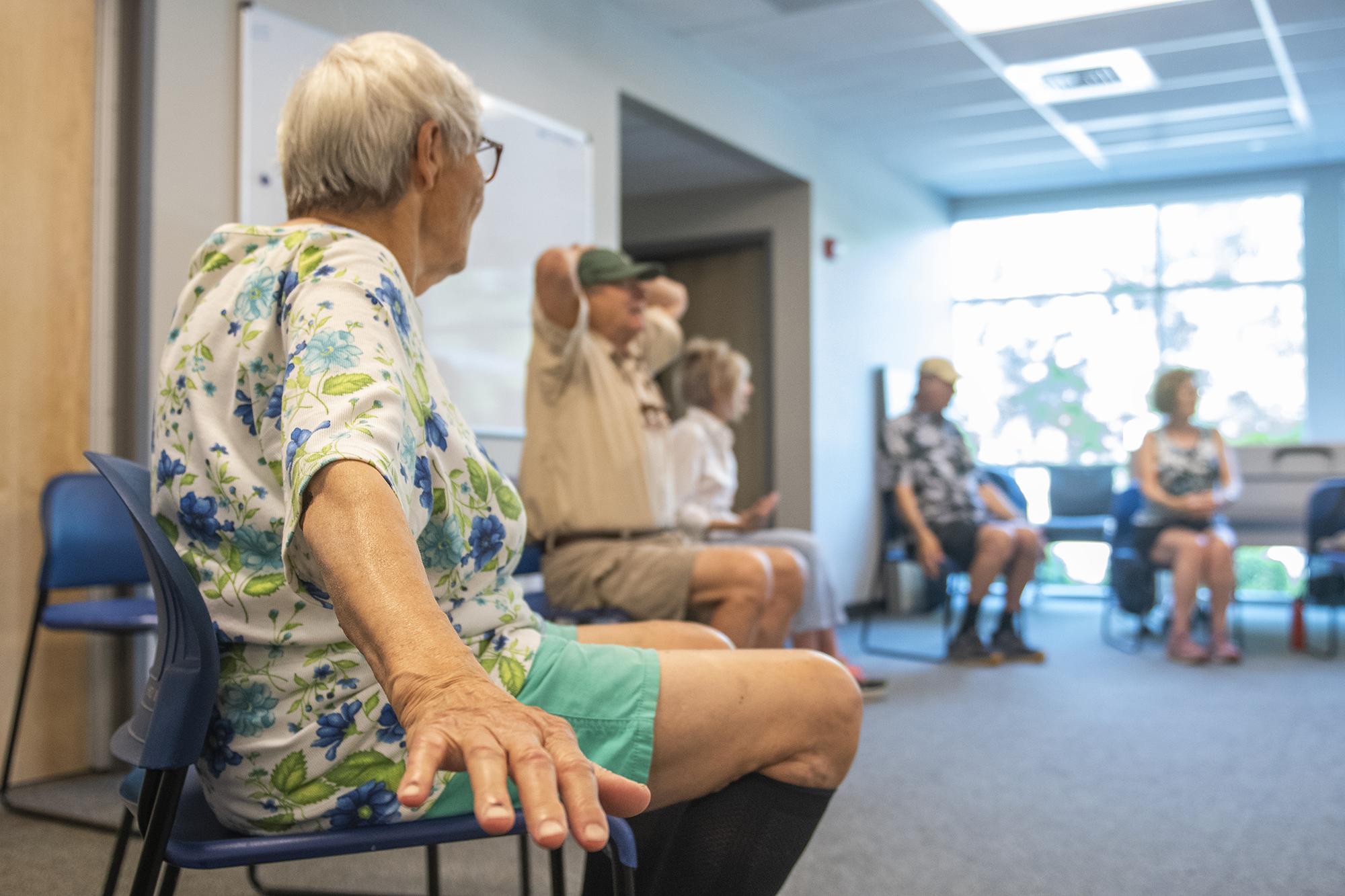 Elders doing chair exercises