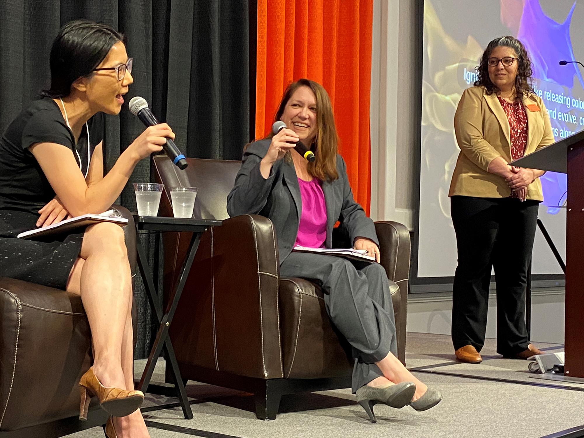 three women on stage talking