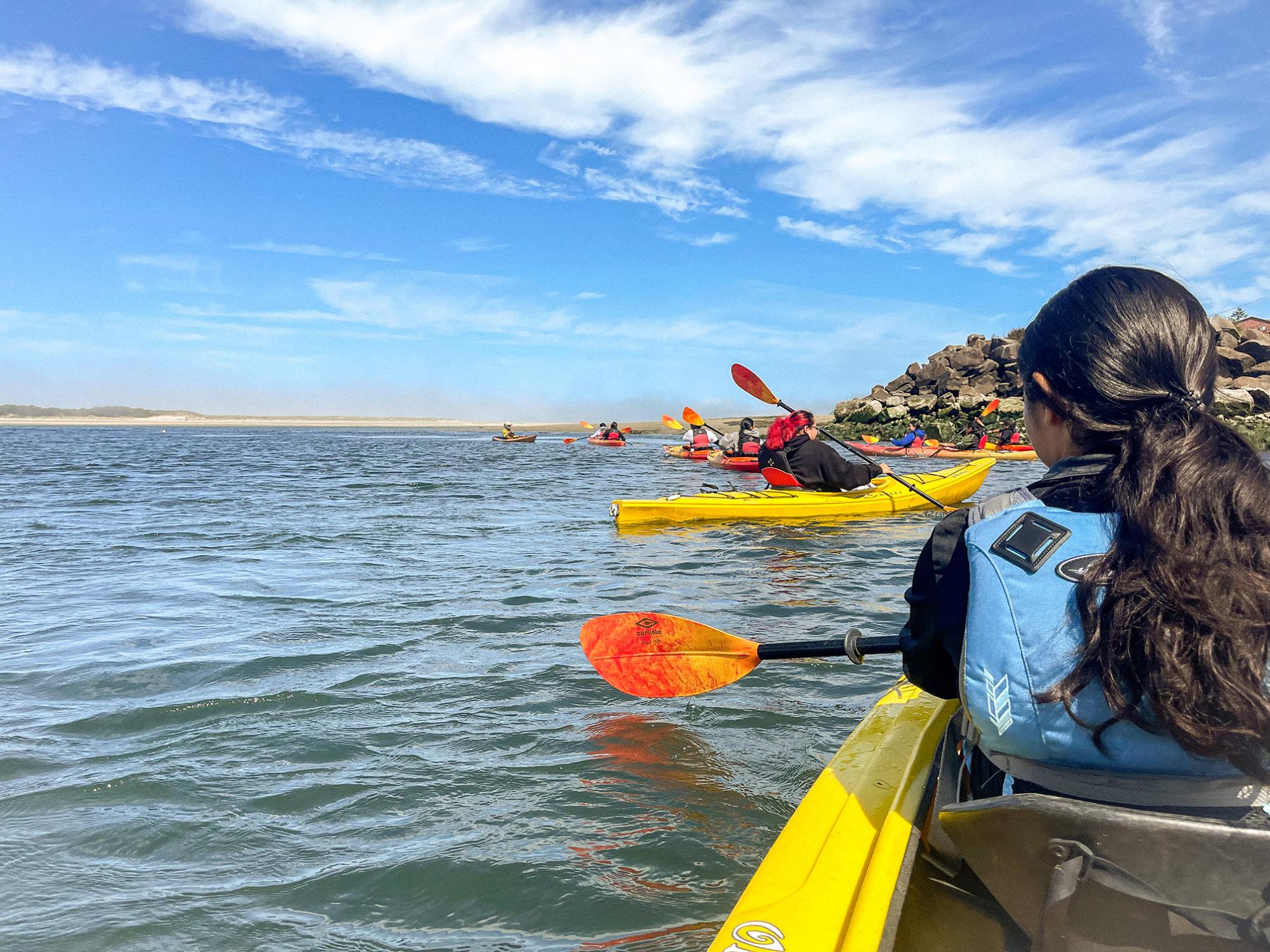 young woman and others kayaking